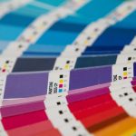 A bunch of different colors of paper on a table