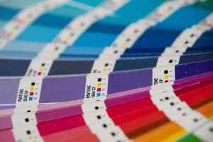 A bunch of different colors of paper on a table