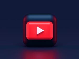 A 3D red play button icon on a dark blue background