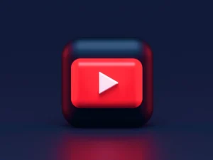 A 3D red play button icon on a dark blue background