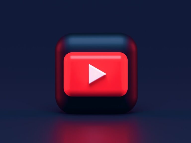 A 3D red play button icon on a dark blue background