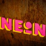 a close up of the word neon on a wall
