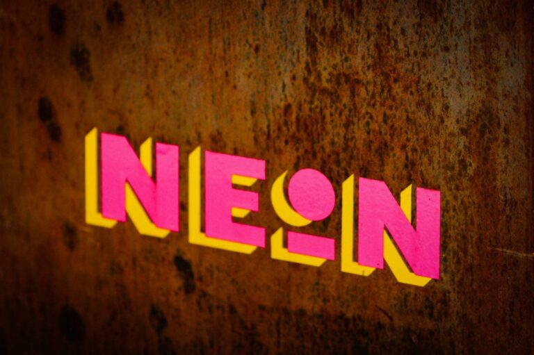 a close up of the word neon on a wall