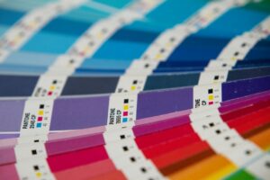 A bunch of different colors of paper on a table